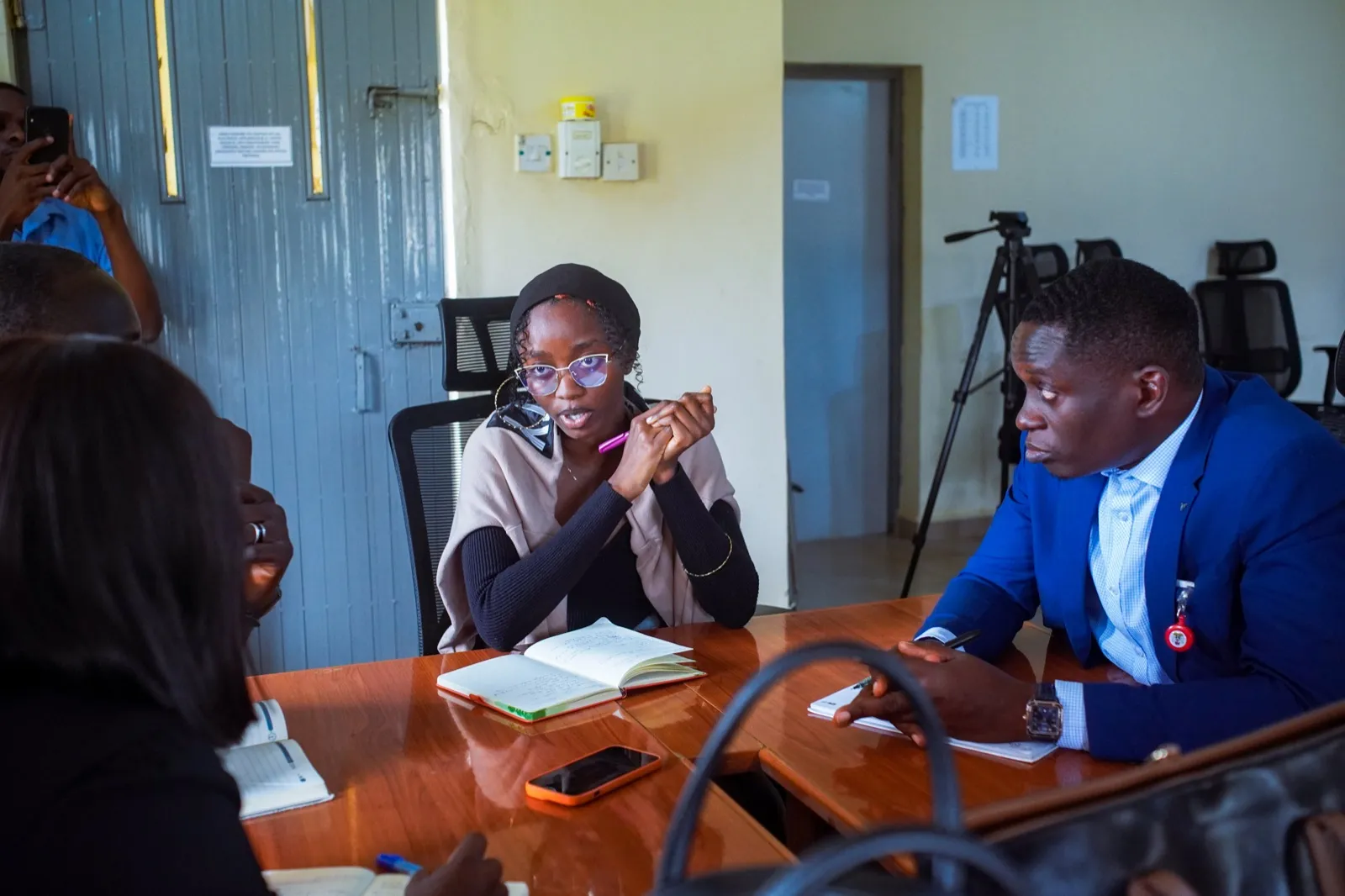 Team members discuss around a table during a training exercise.