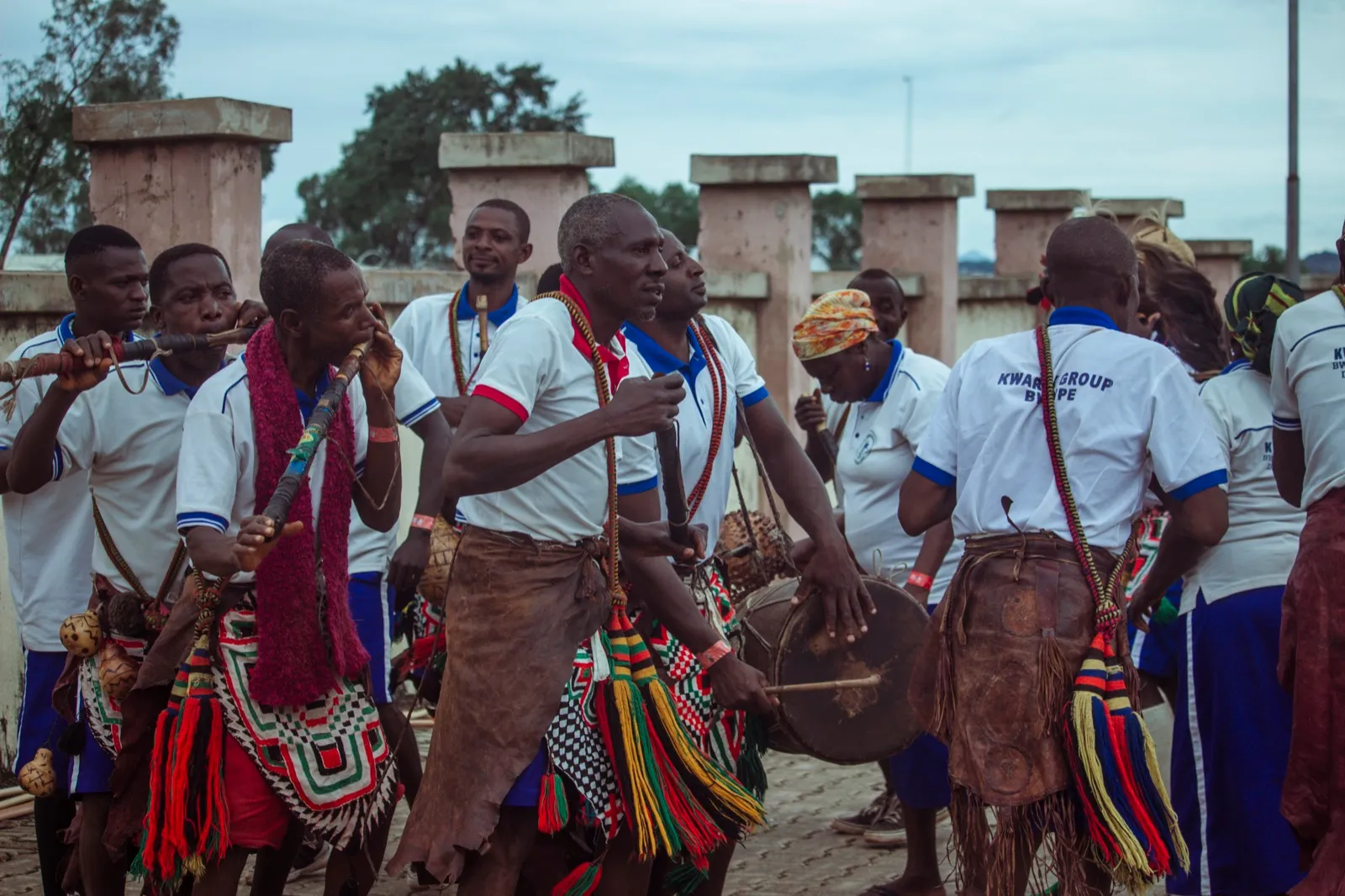 A group of musicians perform together with flutes and traditional instruments.